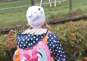 dziewczynka odwrócona plecami przygląda się żyrafie