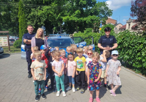 Dzieci z grupy "Biedronek" wraz z ciocią oraz funkcjonariuszami Policji.