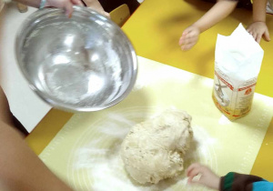 Dzieci z grupy "Motylków" podczas zagniatania ciasta na bułeczki.