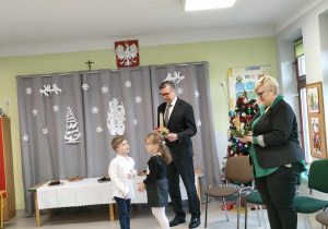 Dwoje dzieci wręcza świąteczny upominek p. Burmistrzowi Miasta Ozorkowa.