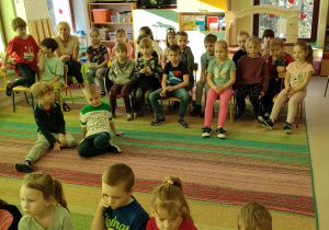 Dzieci z grup: "Biedronek" oraz "Skrzatów" na dywanie podczas występu młodszych koleżanek i kolegów.