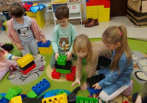 Zabawy konstrukcyjne wśród dzieci z grupy "Biedronek", przy użyciu ogromnych, kolorowych klocków.