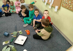 Dzieci siedzą w kole, podczas "burzy mózgów" - "Czego potrzebują rośliny?".