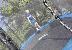 Kuba M. skacze na trampolinie.