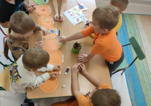 Kilkoro dzieci w zespole tworzy bardzo głodną gąsienice.