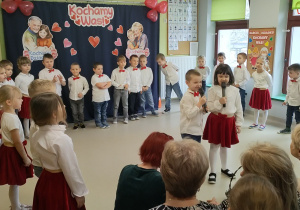 Dwoje dzieci z "Pszczółek" recytuje wierszyk dla Babci.