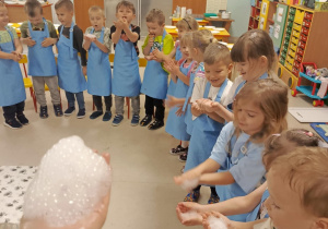 Dzieci z grupy "Motylków" trzymają magicznie znikającą piankę na rączkach.