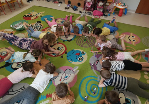 Dzieci młodsze podczas ćwiczenia z kolorową klepsydrą żelową.