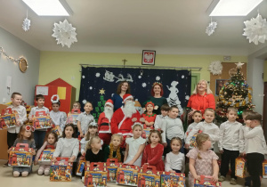 Wspólne, świąteczne zdjęcie pamiątkowe dzieci z grupy V wraz z Mikołajem.