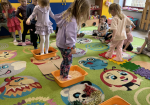 Dzieci po kolei pokonują ścieżkę sensoryczną.