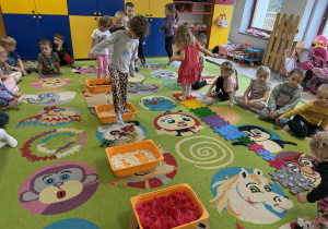 Dzieci po kolei pokonują ścieżkę sensoryczną.