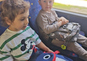Dzieci jadą autobusem do sali zabaw.